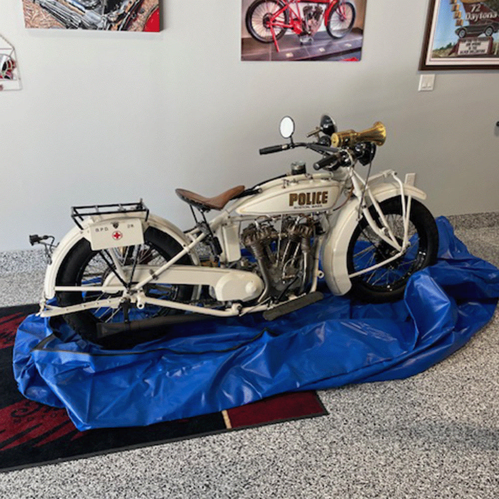 Motorcycle centered on the open FloodVault Moto envelope.